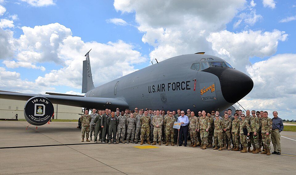 Members of the 100th Maintenance Group and 100th Operations Group pose for a photo with retired Master Sgt. Dewey Christopher, a former 351s