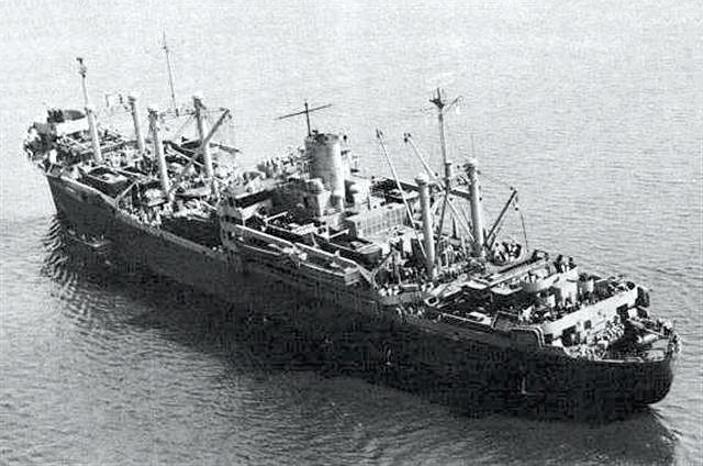 The U.S. Navy attack transport USS Warren (APA-53) at Hampton Roads, Virginia (USA), on 23 August 1943, her decks crowded with a landing cra